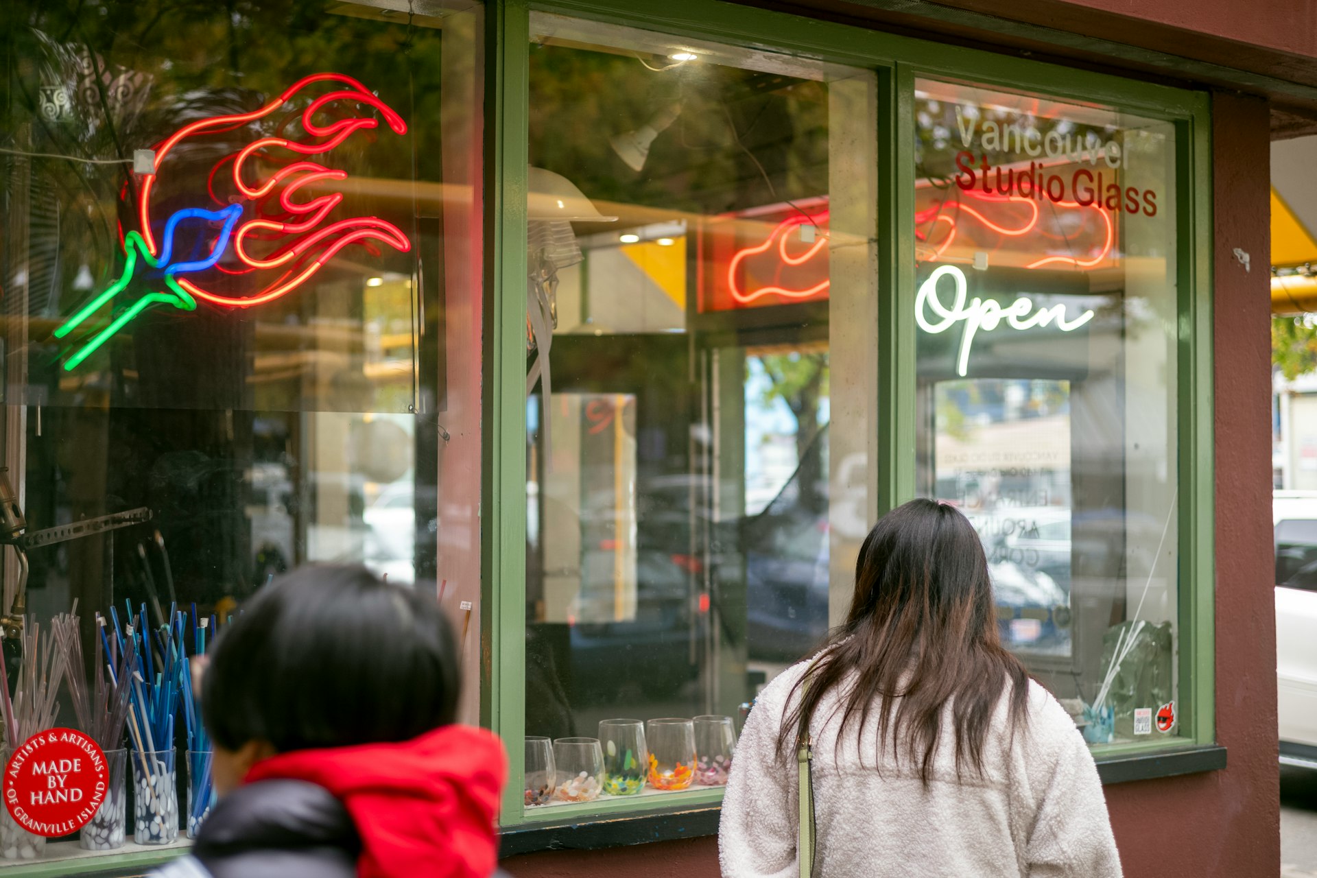 a woman standing in front of a store window